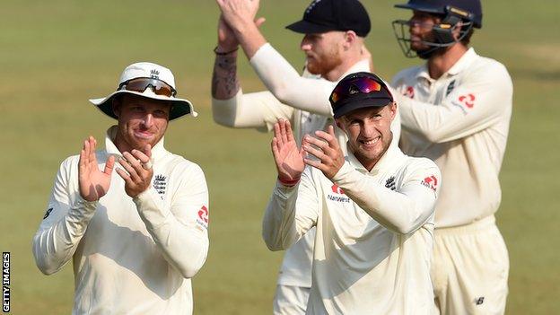 England's Jos Buttler (left) and Joe Root (right) applaud the fans as they walk from the field following third Test victory over Sri Lanka