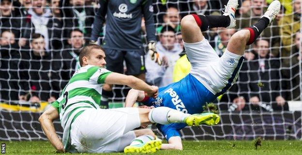 Kenny Miller receives a heavy challenge from Celtic defender Jozo Simunovic