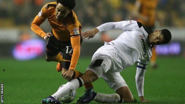 Derby County's Curtis Davies slides in against Wolves winger Helder Costa