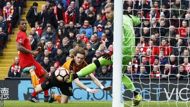 Liverpool midfielder Gini Wijnaldum and keeper Loris Karius look on aghast after Richard Stearman was allowed to steal in unmarked to head Wolves in front after just 56 seconds at Anfield