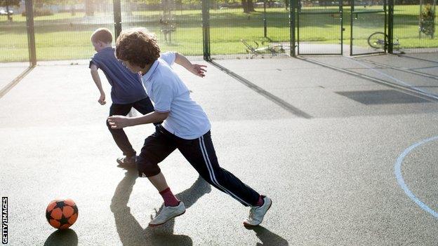 young people playing football