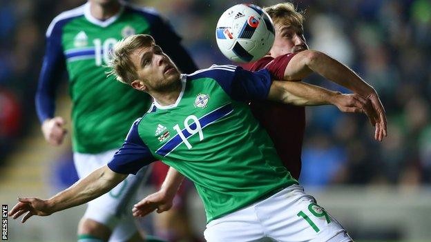 Jamie Ward and Aleksejs Visnakous battle for possession at Windsor Park