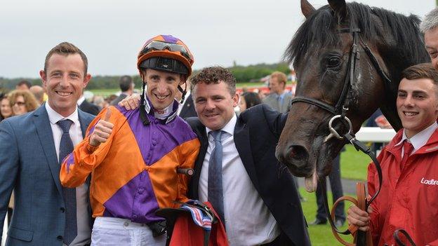 George Baker celebrates after winning the St Leger