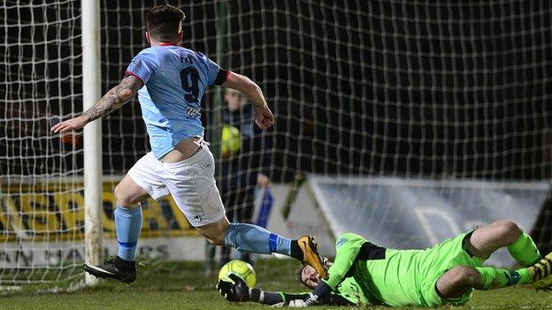 Cathair Friel watches his shot beat Aaron Hogg and go into the Ards goal at the Showgrounds
