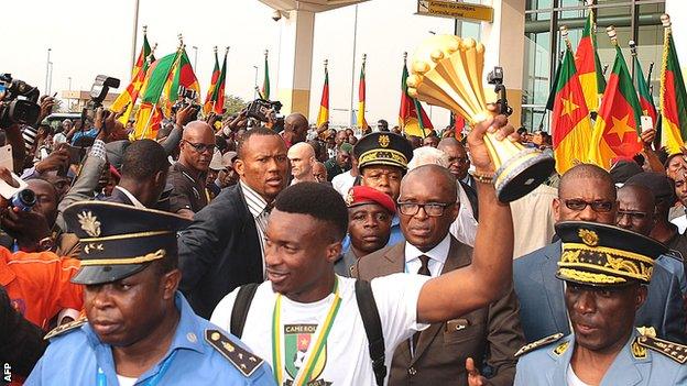 Captain Benjamin Moukandjo carries the Nations Cup trophy onto Cameroonian soil