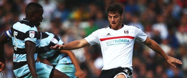 Chris Martin contests a ball for Fulham against QPR