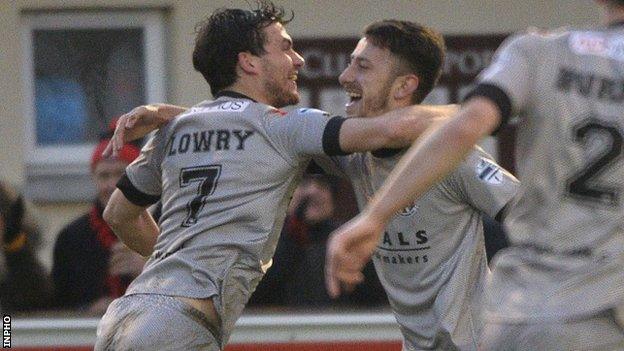 Philip Lowry rushes in to congratulate Crues scorer Jordan Forsythe in the league win over Ballinamallard