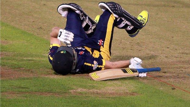 Glamorgan's Graham Wagg falls to the ground after being hit on the head