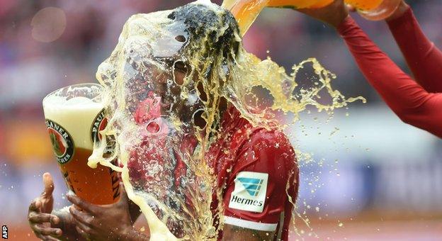 Douglas Costa is soaked with beer