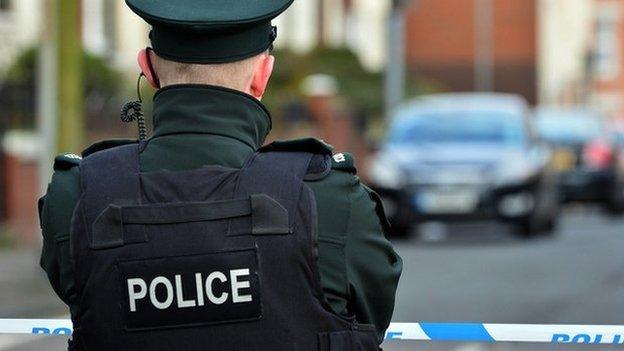 A police officer standing at a cordon