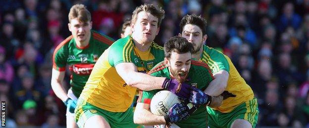 Donegal duo Hugh McFadden and Ryan McHugh challenge Mayo's Kevin McLaughlin