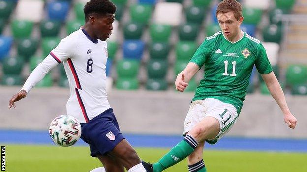 Shane Ferguson clears for Northern Ireland in Sunday's defeat by USA