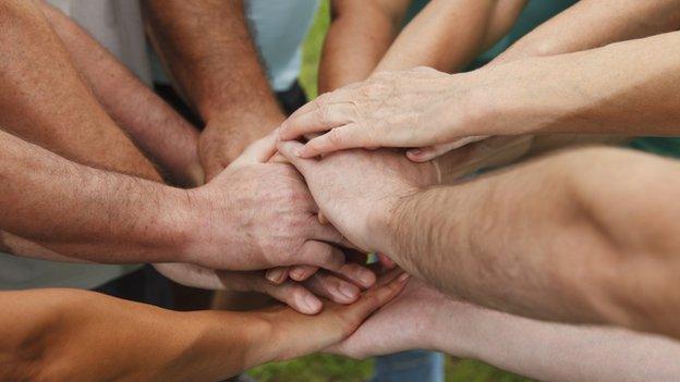 Group of people holding hands