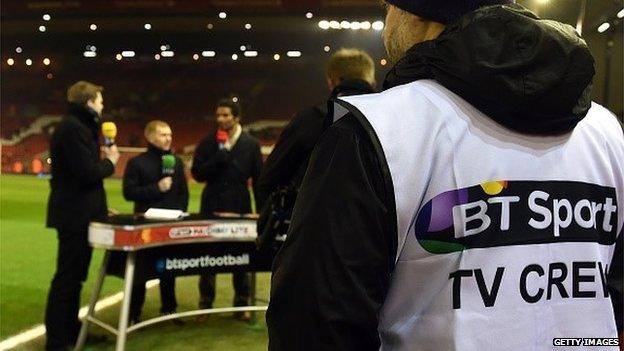 A BT Sport employee watches some of his firm's football pundits