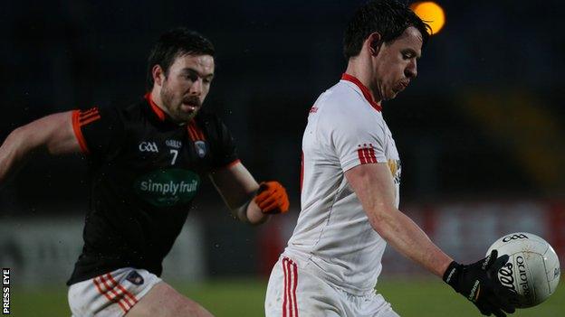 Tyrone's Mattie Donnelly attempts to burst away from Armagh's Aidan Forker