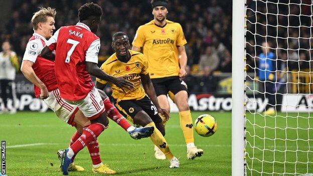 Arsenal's Martin Odegaard scores a goal against Wolves at Molineux ion the Premier League