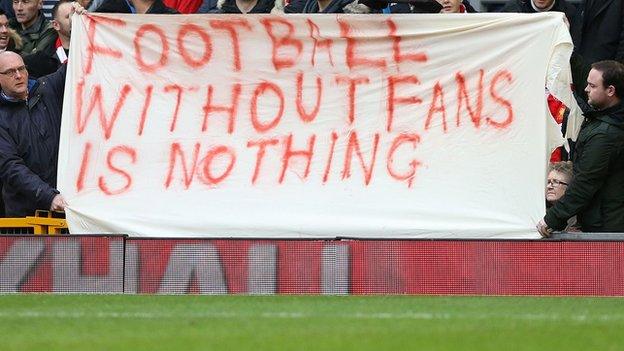 Liverpool fans hold up a banner during the game against Sunderland