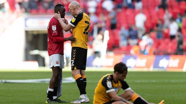 Carlos Mendes Gomes of Morecambe and Kevin Ellison of Newport County after the Sky Bet League lay-off final at Wembley Stadium