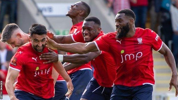 Maziar Kouhyar (left) celebrates scoring for York City