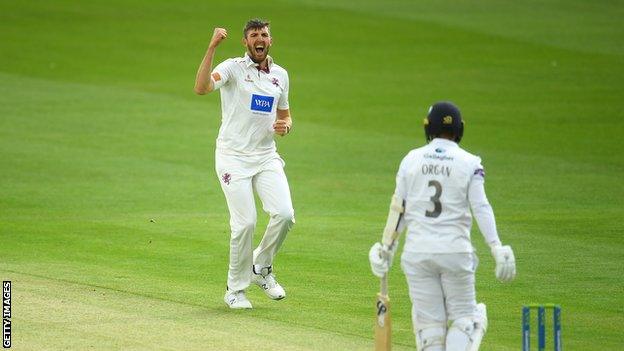 Craig Overton celebrates a wicket