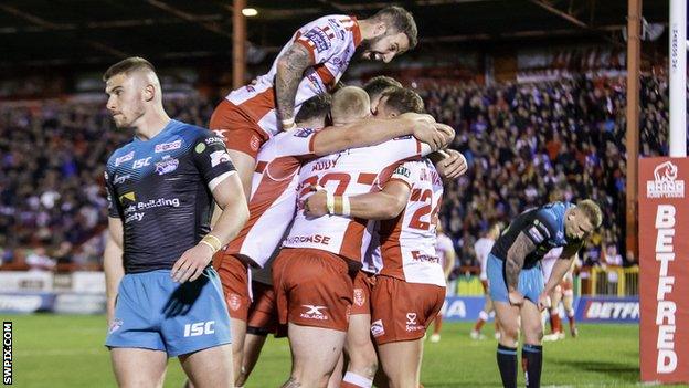 Hull KR players celebrate a try against Leeds Rhinos