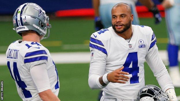 Dak Prescott talks to Andy Dalton before the Dallas Cowboys' game with the New York Giants in October 2020