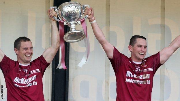 Cushendall captain Arron Graffin and vice-captain Sean Delargy lift the cup after winning the Antrim SHC title