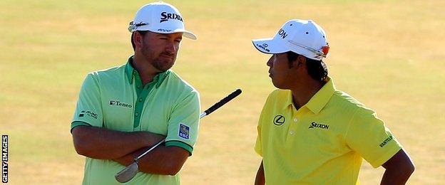 Graeme McDowell talks to Japan's Hideki Matsuyama on the 18th green on Friday