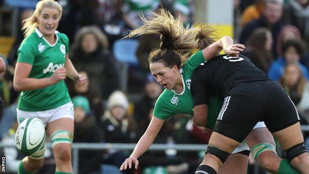 Ireland's Nichola Fryday spills the ball after this heavy challenge from Charlene Gibb of New Zealand