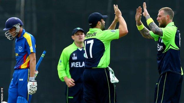 Stuart Thompson celebrates with Ireland team-mate John Mooney after the fall of a Namibian wicket