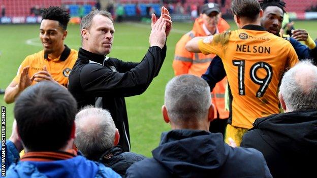 Mike Flynn applauds Newport County fans following the win at Crewe