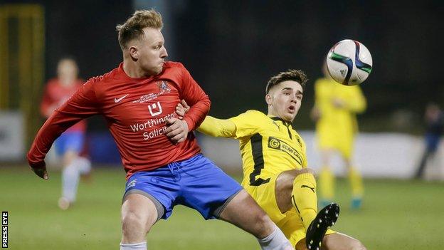 Thomas Lambe of Ards and Cliftonville's Jay Donnelly in action at Solitude