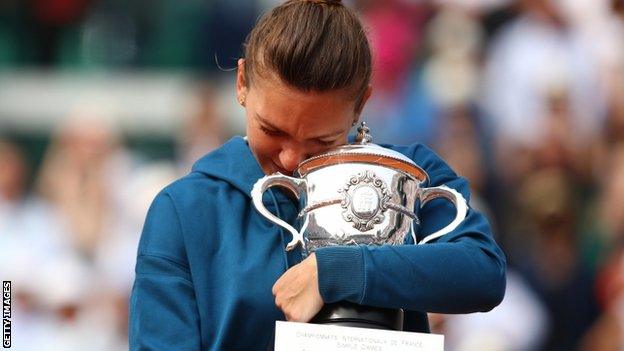 Simona Halep hugs her trophy