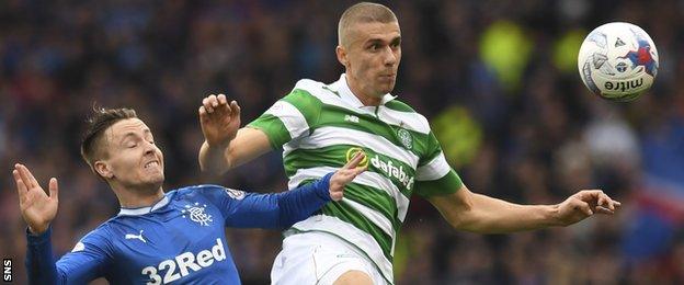 Celtic's Jozo Simunovic (right) holds off Rangers' Barrie McKay