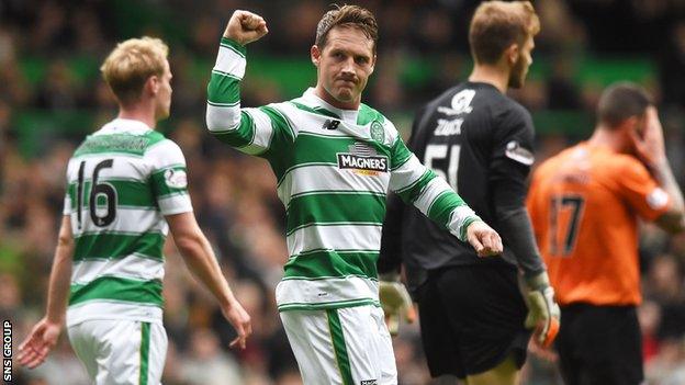 Kris Commons celebrates making it 3-0 to Celtic with a thumping penalty