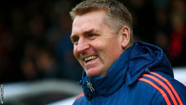 Brentford boss Dean Smith looks on from the dugout