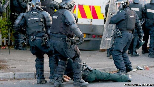 Bottles, bricks and metal bolts have been thrown at police