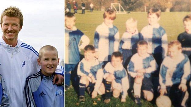 A young Harry Kane poses for a photograph with David Beckham