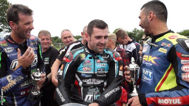 Double Superbike winner Michael Dunlop (sitting) shares a laugh with Derek Sheils and Michael Sweeney at Armoy last year