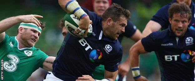 Richie Vernon of Scotland bursts past Ireland's Gordon D'Arcy during the match at the Aviva Stadium in Dublin