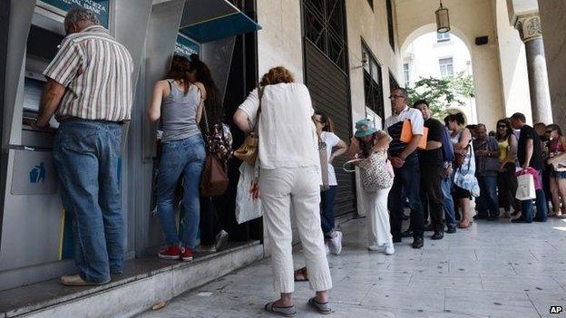 People queuing outside a cashpoint in Greece