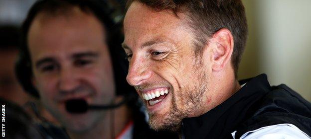 Jenson Button smiles in the McLaren garage