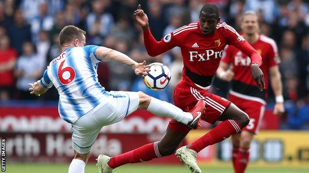 Abdoulaye Doucoure of Watford is challenged by Jonathan Hogg of Huddersfield Town