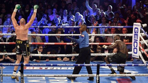 Tyson Fury celebrates after knocking down Deontay Wilder