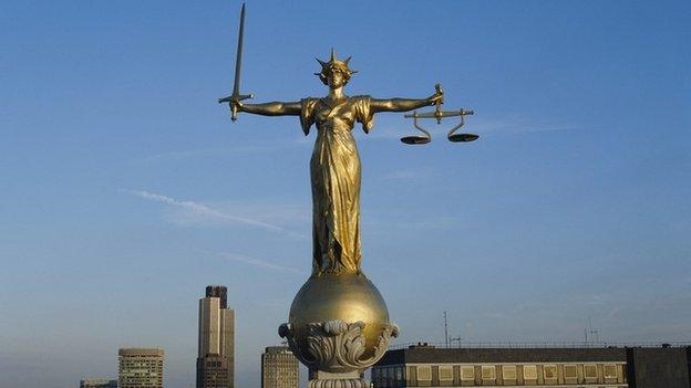 Statue of the Scales of Justice on the rooftop of the Old Bailey building