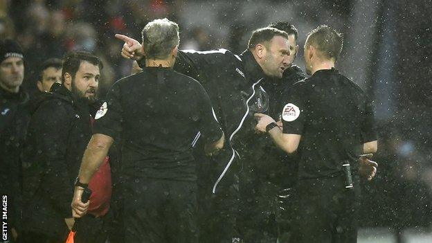 Ian Evatt speaks to the referee Ross Joyce