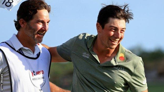 Viktor Hovland and his caddie celebrate after winning the Hero World Challenge in the Bahamas