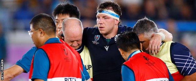 Scotland flanker Hamish Watson is helped from the field injured