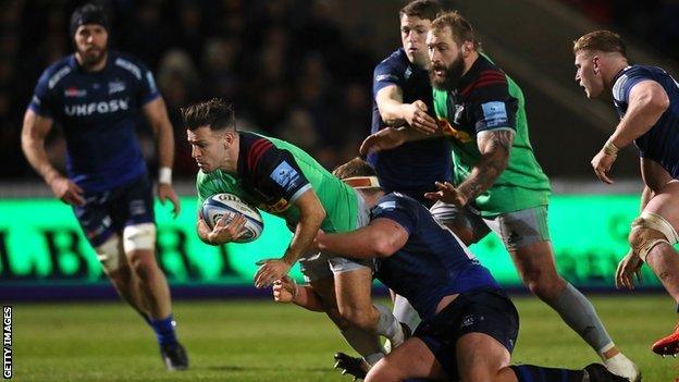 Danny Care of Harlequins is tackled by Ross Harrison of Sale Sharks during a Premiership Rugby match