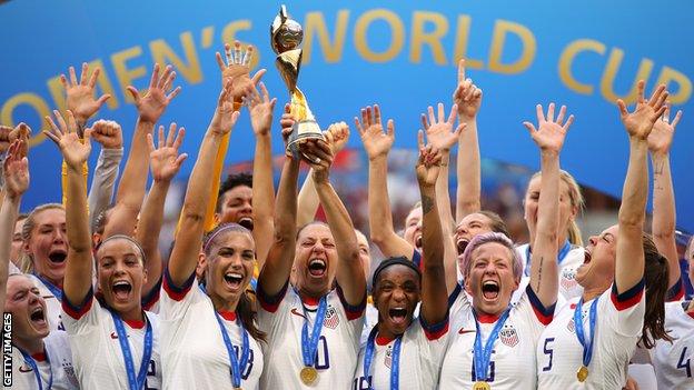 United States players hold up the World Cup